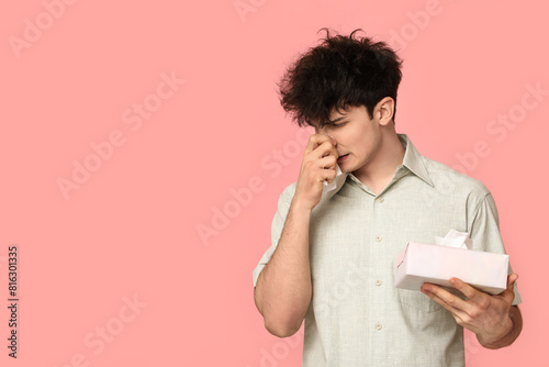 Young man with runny nose o...