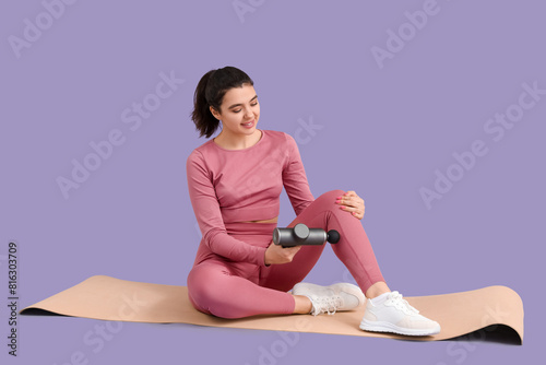 Sporty young woman massagin...