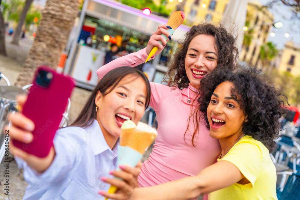 Friends taking selfie while eating ice cream in the city Friends taking selfie while eating ice cream in the city