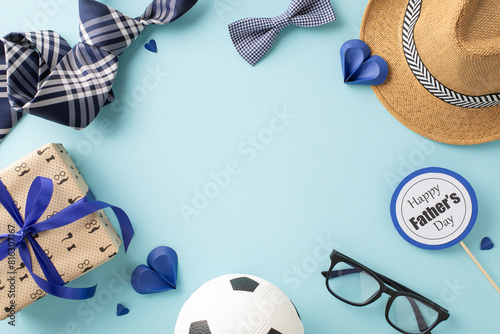 A thoughtful display of Father's Day gifts featuring a hat, ties, a soccer ball, glasses, and a gift box on a blue background