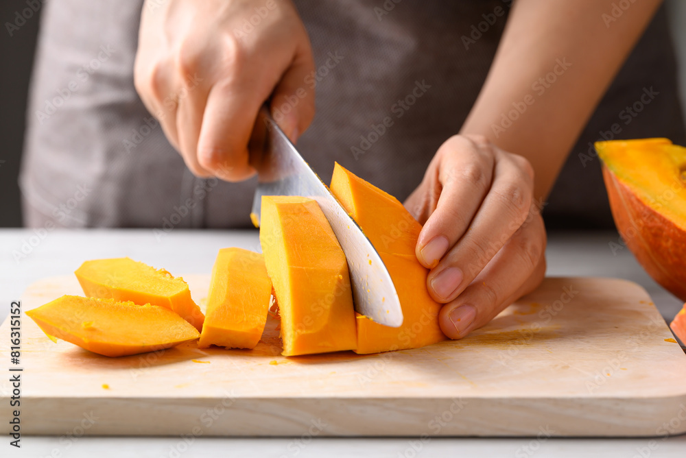 Orange Hokkaido pumpkin with hand holding knife and chopped, Homemade cooking Orange Hokkaido pumpkin with hand holding knife and chopped, Homemade cooking