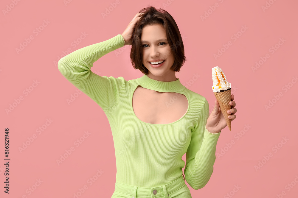 Beautiful young woman with sweet ice-cream in waffle cone on pink background Beautiful young woman with sweet ice-cream in waffle cone on pink background