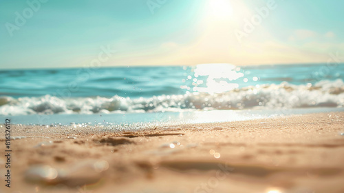 Close up shot of foaming sea wave and sand with beautiful blurred sunny beach background © @foxfotoco