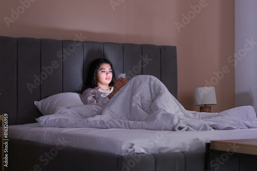 Young woman with mobile pho...