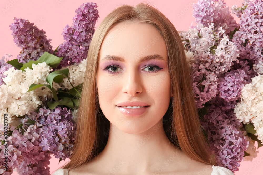 Beautiful young happy woman with lilac flowers on pink background Beautiful young happy woman with lilac flowers on pink background
