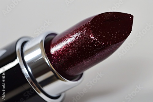 Close-Up of a Red Metallic Lipstick Tube with Glittery Texture
