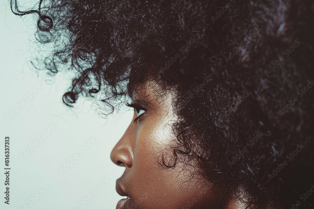 Stylized Portrait of Woman with Curly Hair and Glowing Skin