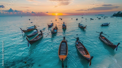 morning sunrise on beach with many wooden long tail boats parking on blue sea at Sunrise beach photo