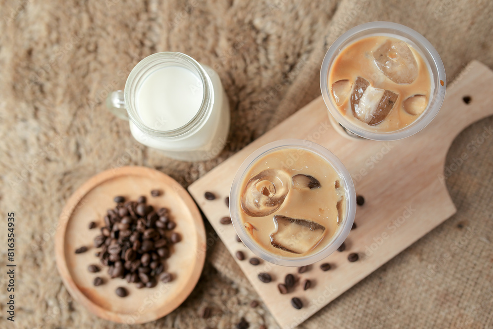 Delicious iced coffee, mocca, and chocolate drinks with coffee beans on white wooden table
Delicious iced coffee, mocca, and chocolate drinks with coffee beans on white wooden table