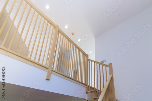 An interior of new house with wooden handrails  railings