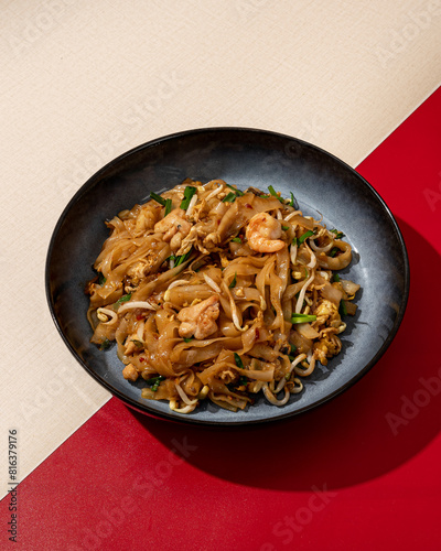 Asian fried kwetiaw served with seafood topping photo