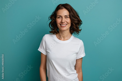 Portrait of smiling mature woman in white t-shirt with Copy space for text or logo. White tshirt mockup.