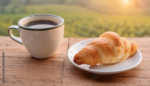 Croissant and white coffee cup