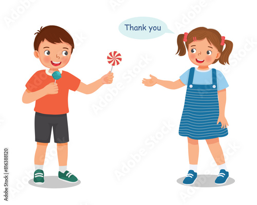 Cute little boy sharing food sweet candy to his girl friend