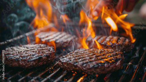 Juicy burgers cooking on a grill, with flames and smoke rising, capturing a perfect BBQ moment.