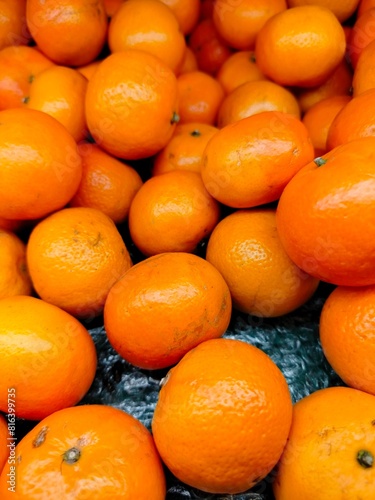 Ripe orange. Stacked citrus fruits are sold at supermarkets. Sweet fruits are fresh and healthy.