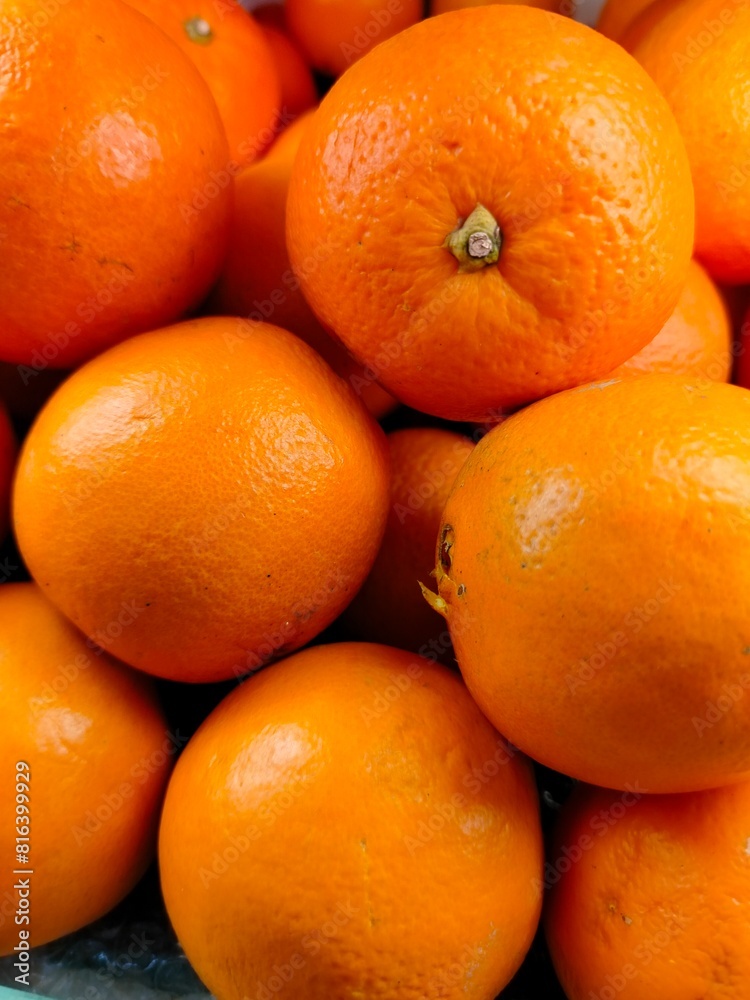 Ripe orange. Stacked citrus fruits are sold at supermarkets. Sweet fruits are fresh and healthy. Ripe orange. Stacked citrus fruits are sold at supermarkets. Sweet fruits are fresh and healthy.