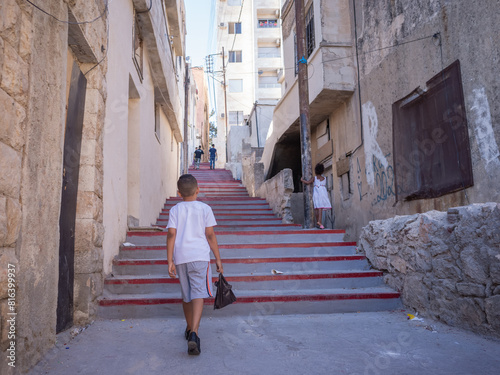 Cuadro en lienzo a boy walking on the stairs of street alleyway in capital amman