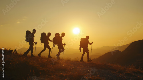 Silhouettes of four young hikers with backpacks are walking in mountains at sunset time   Generative AI