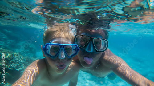 Joyous moments of a Caucasian father and son snorkeling together, exploring the vibrant underwater world of a clear blue sea