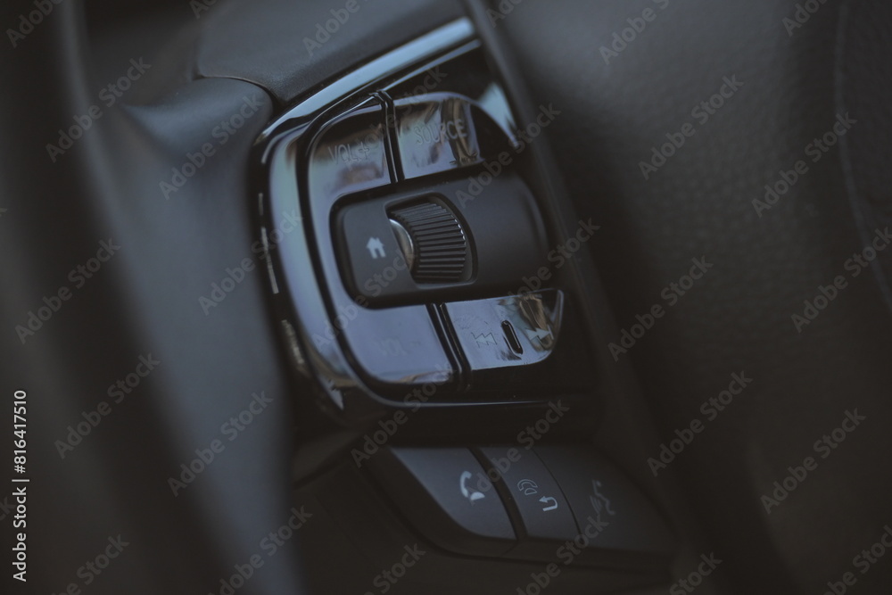 interior view of car with black leather, close up steering wheel with button interior view of car with black leather, close up steering wheel with button