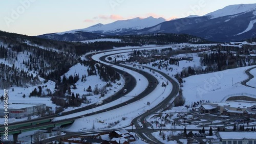 Highway and intersection in Colorado, United States. Winter mountain scenery with snowy peaks, sunset. photo