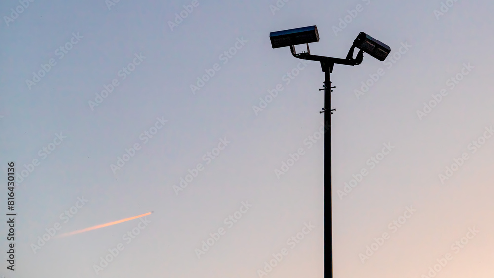 Security video surveillance cameras against the evening sky Security video surveillance cameras against the evening sky