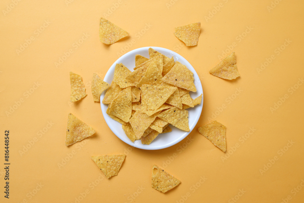 Top View Of Corn Nachos Chips On Plate Isolated On Yellow Background Top View Of Corn Nachos Chips On Plate Isolated On Yellow Background
