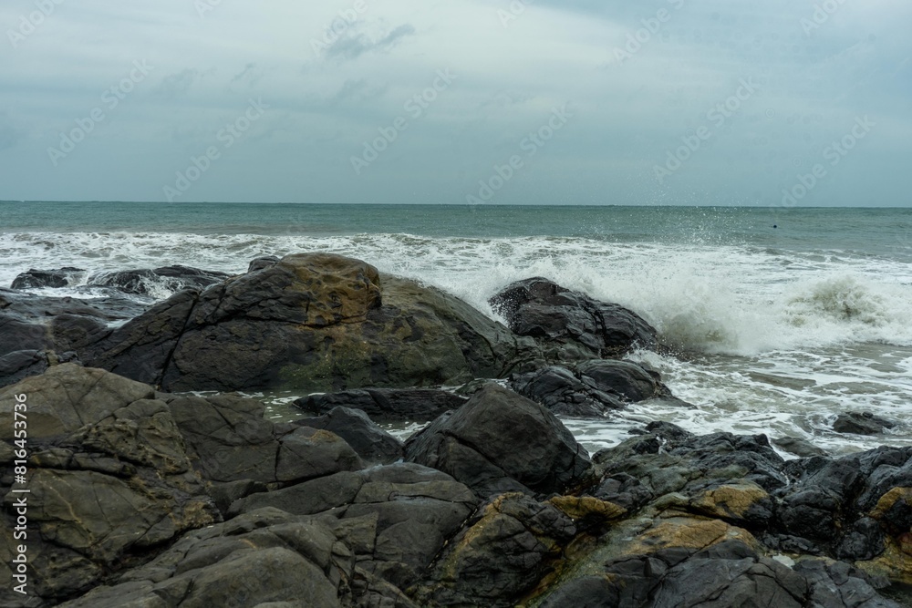 Image of a wave crashing on the rock