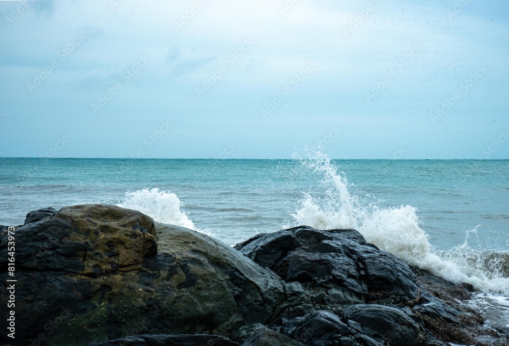 Image of a wave crashing on the rock Image of a wave crashing on the rock