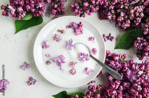 Bowl of Sugar With Lilac Blossoms on a Textured Background