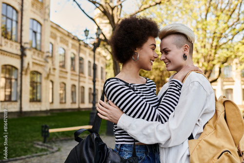 Εκτύπωση καμβά A multicultural lesbian couple hugs affectionately in front of a building on a university campus