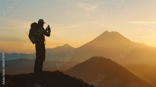 Side view silhouette of unrecognizable male hiker standing on mountainous hill against sunset sky while taking photograph of nature using smartphone at nevado volcano in toluca mexico : Generative AI photo