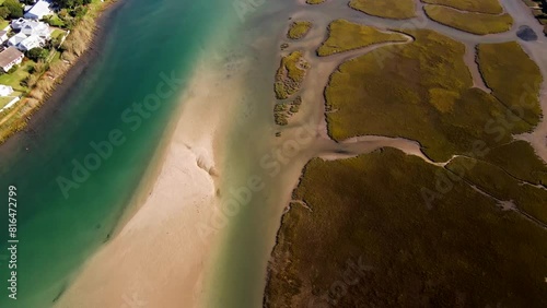 Clear water of Goukou estuary in Stilbaai and tidal wetland. Drone pullback photo