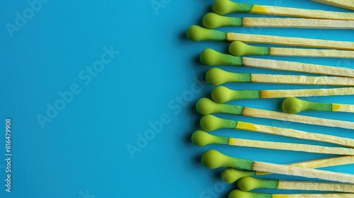 Green matchboxes arranged on a blue background in a horizontal layout