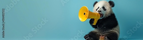 Baby panda holding a yellow megaphone, light blue background, looking playfully to the side photo