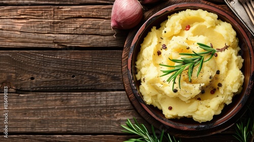 Closeup of bowl of mashed potatoes on wooden surface photo