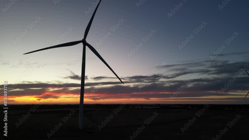 Silhouette of wind turbine spinning at twilight. Aerial drone view and sky for copy space Silhouette of wind turbine spinning at twilight. Aerial drone view and sky for copy space