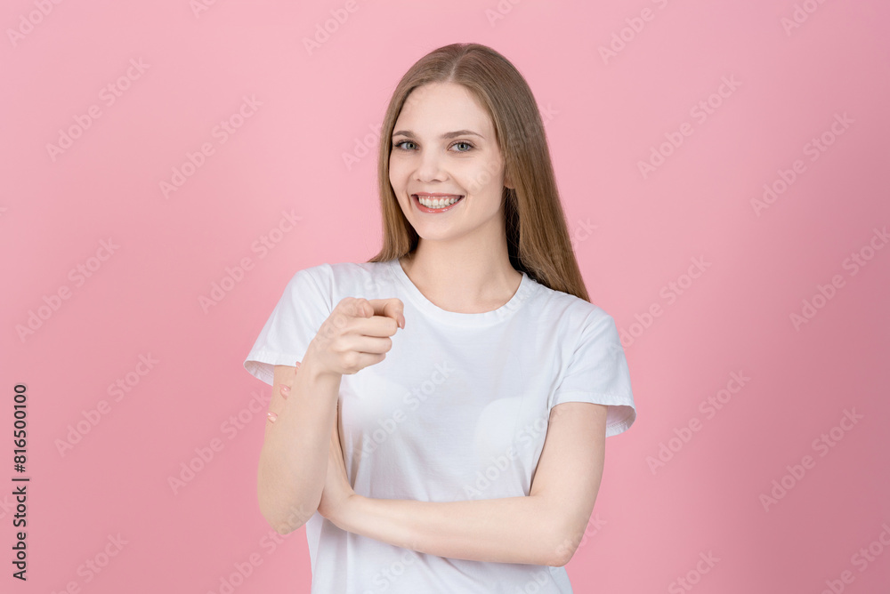 Hey you! Attractive caucasian young blonde woman in casual white t-shirt pointing finger at camera, choosing, inviting people, isolated on pink studio background. Hey you! Attractive caucasian young blonde woman in casual white t-shirt pointing finger at camera, choosing, inviting people, isolated on pink studio background.