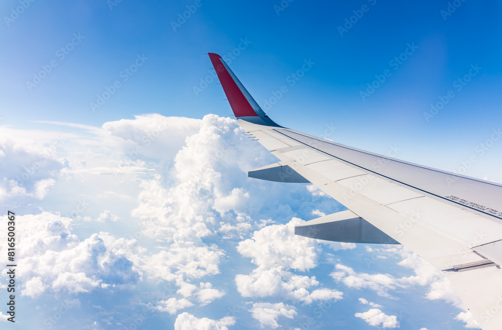 View from the airplane window at a beautiful cloudy sky and the airplane wing View from the airplane window at a beautiful cloudy sky and the airplane wing