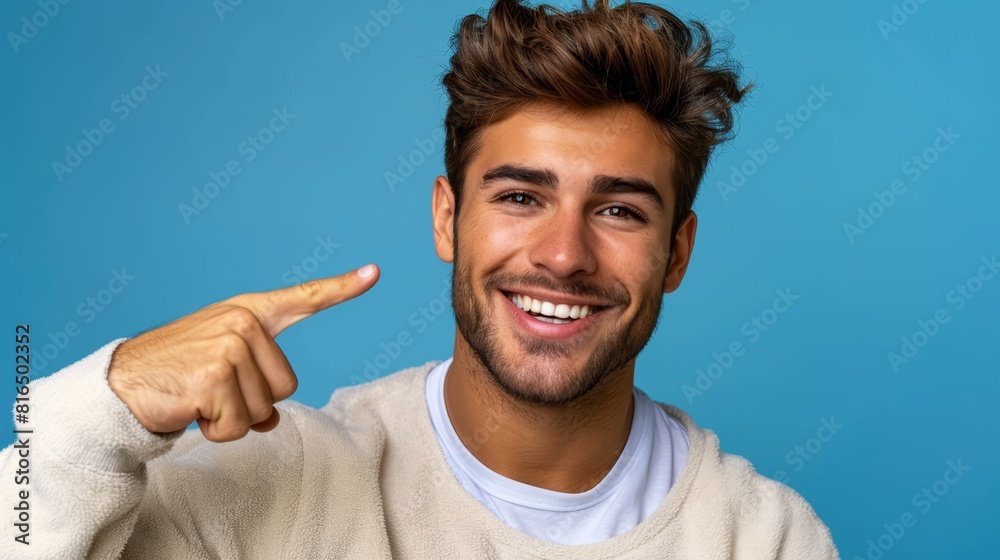 A man in a white sweater, sporting a goatee and smiling directly at the camera A man in a white sweater, sporting a goatee and smiling directly at the camera