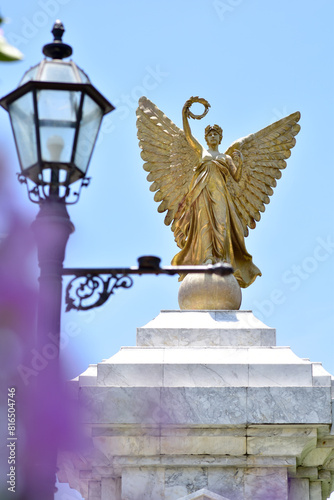 SAMUTPRAKAN, THAILAND - May 16, 2024: Statue of The Golden Angel Independence Monument at Assumption University, Suvarnabhumi Campus, Thailand. photo
