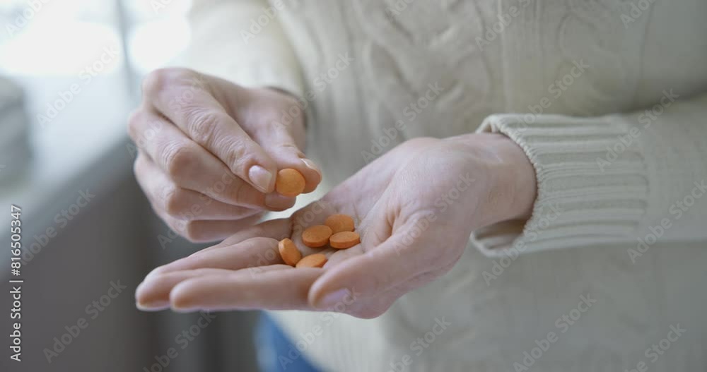 pharmacy and treatment concept - close up view of Caucasian woman holding Vitamin C tablets in her palm