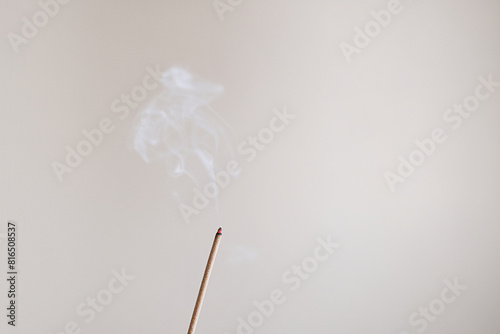 Burning incense stick close up.