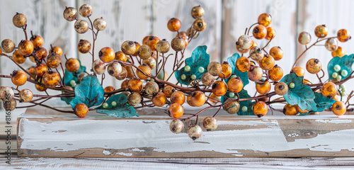 Whitewashed wood adorned with teal and amber berries Memorial Day chic.