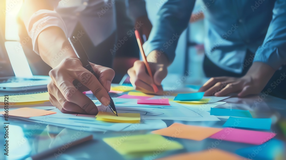 Business people meeting at office writing memos on sticky notes. planning strategy and brainstorming, colleagues thinking concept
