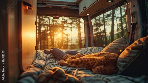 A view of a sunset over a lake from the inside of a camper van. © Awais