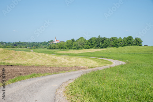walkway in rural landscape with fields beside, towards Andechs cloister, upper bavaria