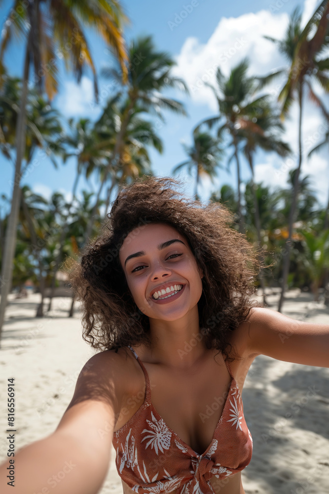 Smiling happy ethnic woman taking selfie photography at tropical beach with white sand and palm beach. Summer vacation in exotic resort, travel photo in a tropical paradise. Smiling happy ethnic woman taking selfie photography at tropical beach with white sand and palm beach. Summer vacation in exotic resort, travel photo in a tropical paradise.