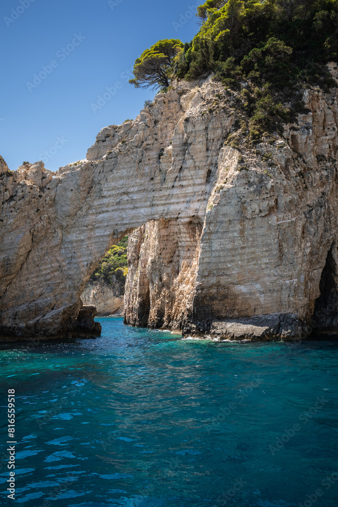 Vertical Stony Arch with Turquoise Ionian Sea in Greece. European Summer Landscape of Keri Caves in Zakynthos. Vertical Stony Arch with Turquoise Ionian Sea in Greece. European Summer Landscape of Keri Caves in Zakynthos.